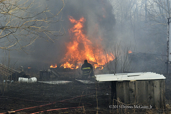 brush fire spreads to junk yard