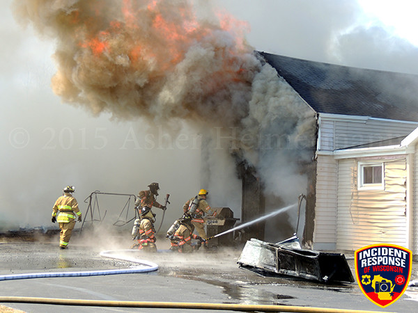 firemen battle heavy fire at a house fire