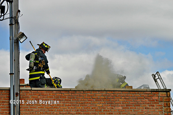 firemen on roof with smoke