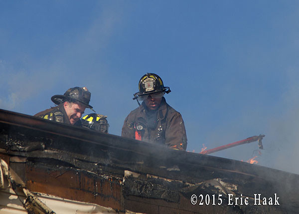 firemen on roof of fire building