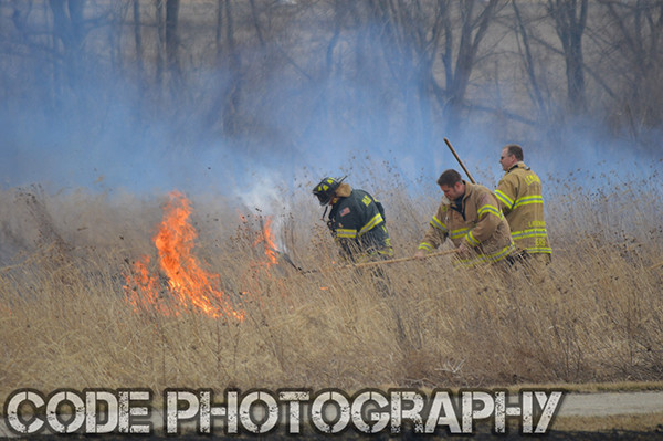 firemen extinguish grass fire