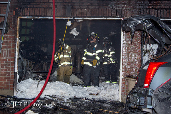 firemen overhaul garage at night