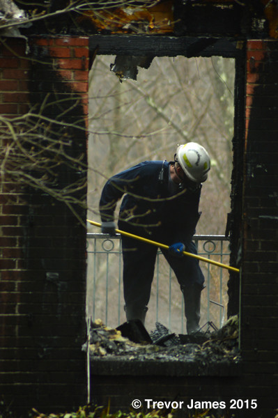fire investigator sifting through debris