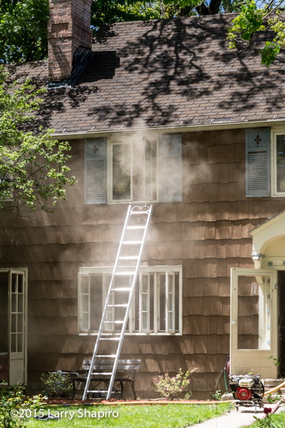 ladder to the window with smoke at a house fire