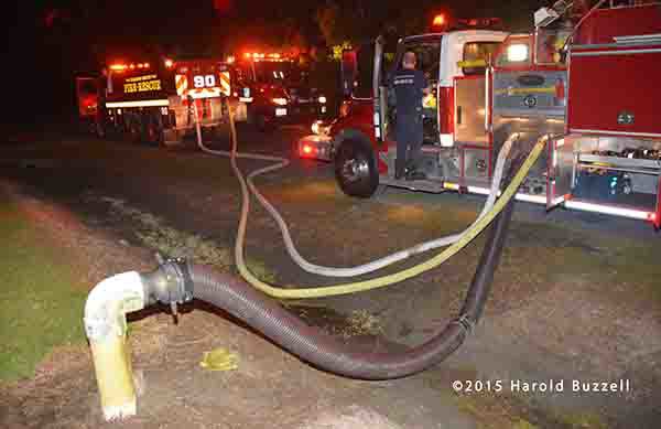 fire engine drafting from a dry hydrant and filling tanker