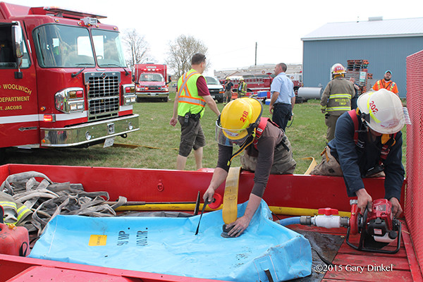 fireman fills portable tank for remote fire