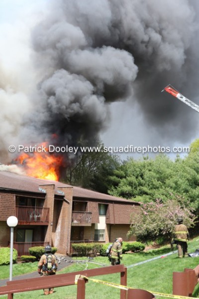 heavy fire through roof of apartment building