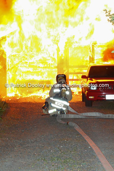 fireman about to hit garage fire at night