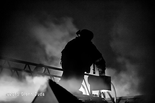 silhouette of fireman at night