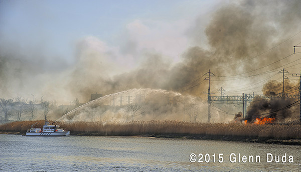 fire boat battles a large brush fire in West Haven CT