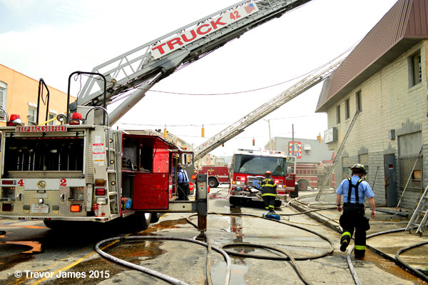 fire department ladder trucks at fire scene