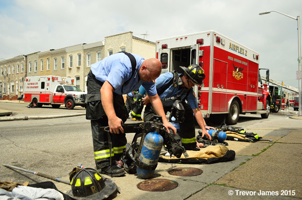 firemen examine SCBA bottles after battling a fire