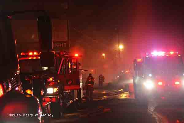 fire trucks engulfed in smoke at night fire scene
