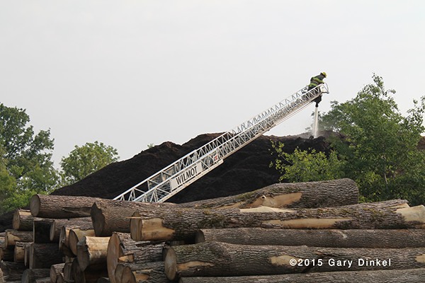 firemen in Canada fight fire in a huge mulch pile