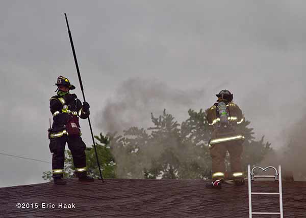 fireman on the roof of house on fire
