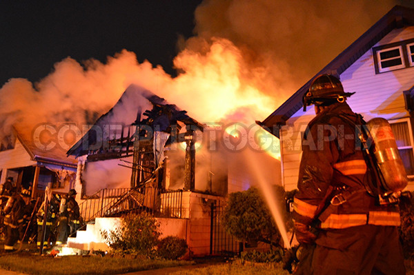 firemen battle house engulfed in fire
