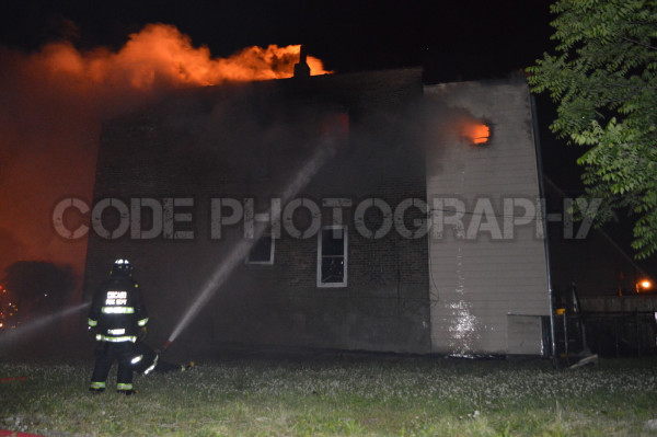 firemen battle house fire at night