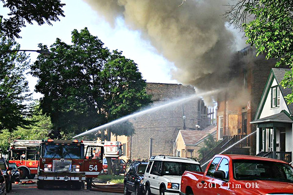 Chicago firefighters use a deck gun at fire scene