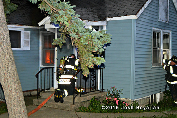 fireman masks up to enter a house