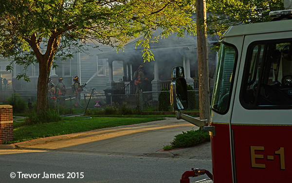 firemen at a small residential house fire