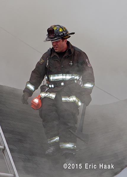 fireman on roof with smoke