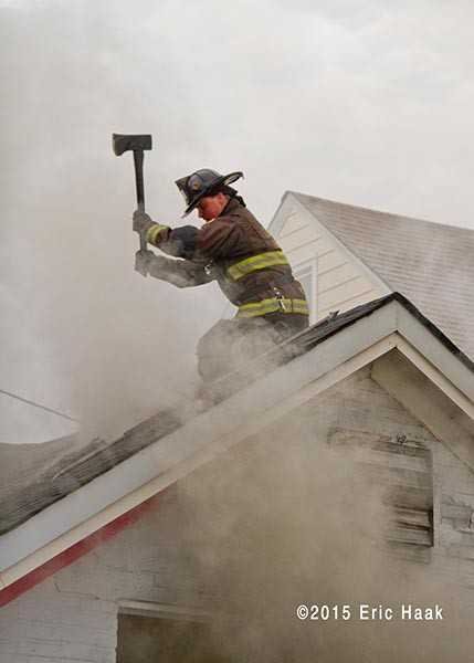fireman on roof with smoke