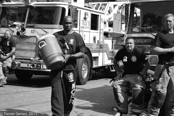 firefighters hydrate on a hot day after fighting a fire