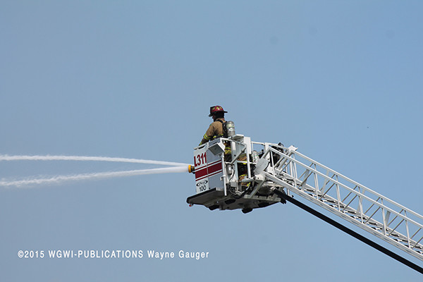firemen use elevated master stream at fire
