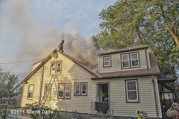 brown smoke from roof of a house fire