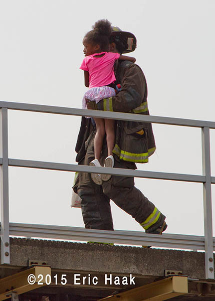 fireman carries young girl to safety