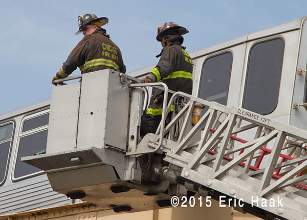 Chicago firemen in tower ladder basket