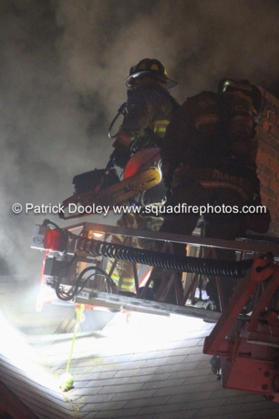 firemen on ladder tip at night