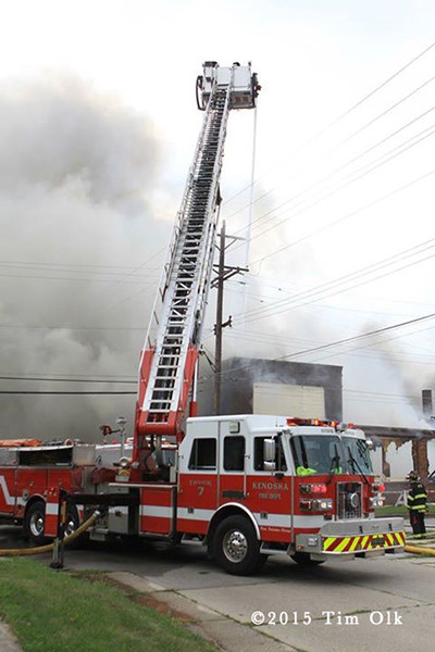 Sutphen aerial ladder working at large fire scene