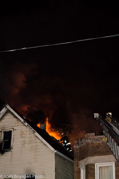 Chicago firemen on roof with heavy fire at night