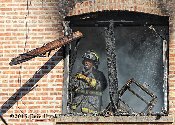 firefighter overhauling after fighting a fire