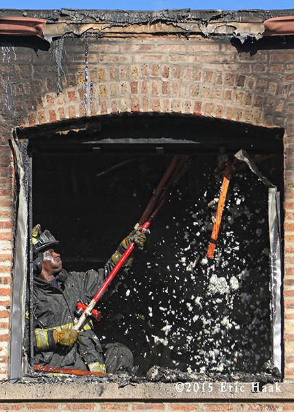 firefighter overhauling after fighting a fire