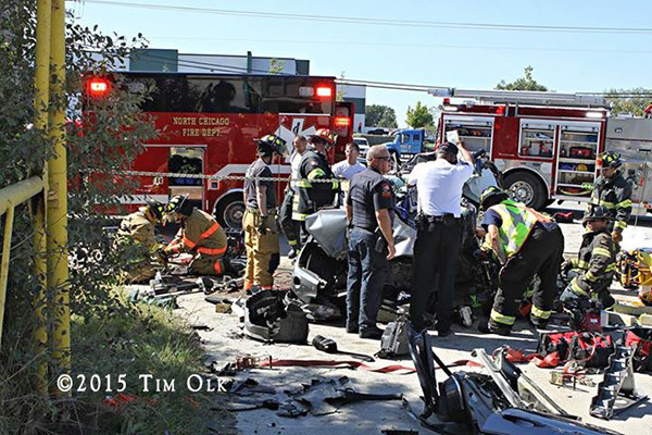 firefighters work to free a driver trapped after a crash