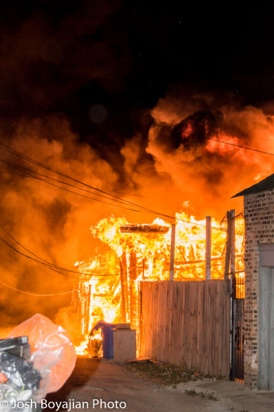 detached alley garage engulfed in flames