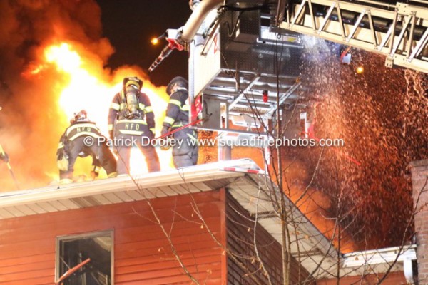 Stuffed tower ladder operating at a night fire in Hartford