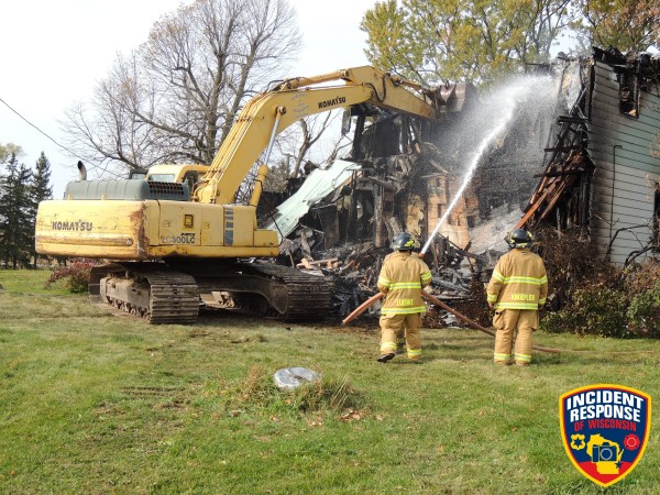 excavator tears down fire ravaged house