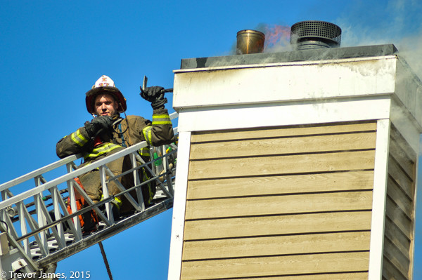 firemen working from an aerial ladder