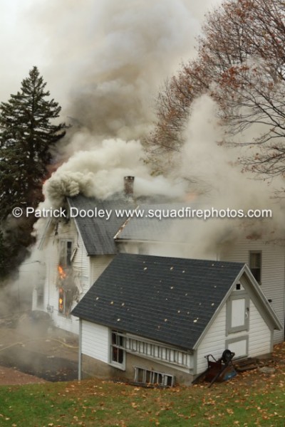 thick smoke blowing out of attic of a house