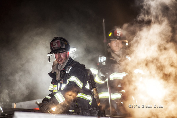 firefighters at night engulfed in smoke