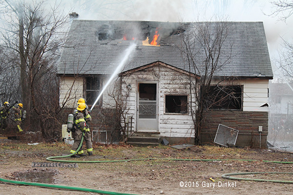 firefighters extinguish fire in a vacant house
