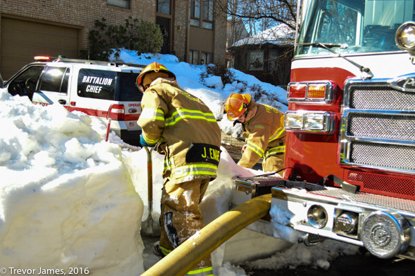 firefighters dig out fire hydrant covered with snow