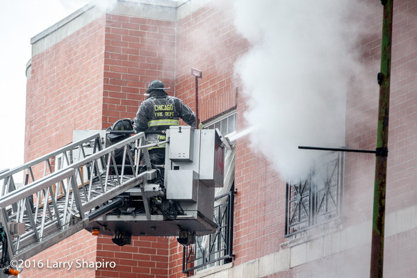 firemen in Pierce tower ladder platform