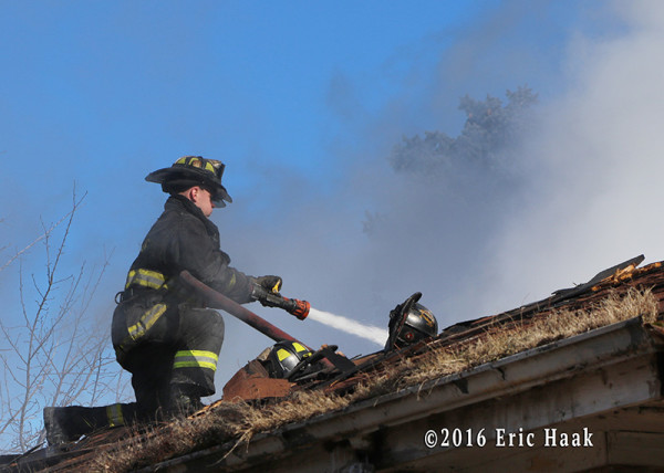 fireman on roof with hose line