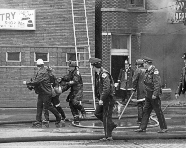 historic fire scene image of a victim rescue