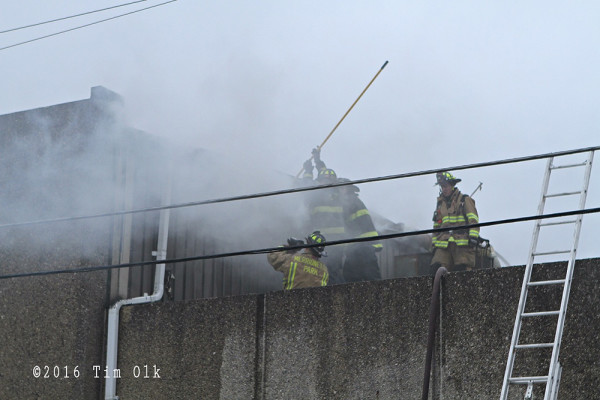 firemen on roof at fire scene