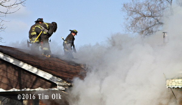 firefighters vent roof at house fire
